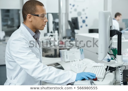 Foto stock: Young Handsome Chemist Working In The Lab