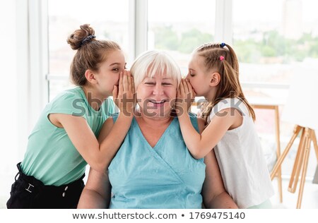 Foto stock: Granddaughter Sharing Secrets With Grandmother