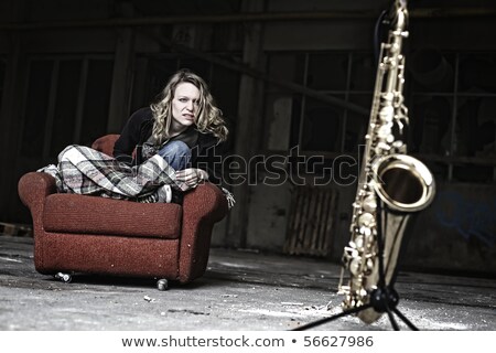 Stock fotó: Furious Girl Starring At Saxophone