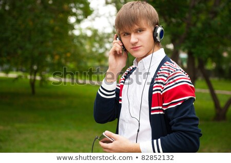 Stok fotoğraf: Student Listening Language Course In Headphones Outside School