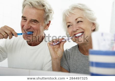 Stock photo: Woman And Man Brushing Teeth