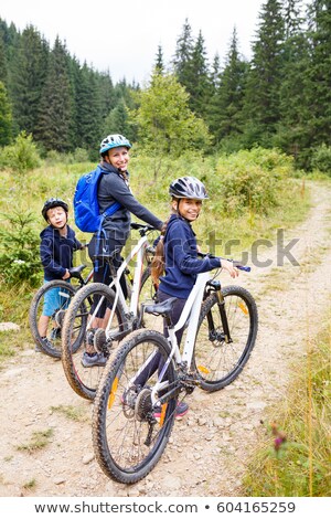 Stock photo: Young Girls Riding Bikes In The Woods