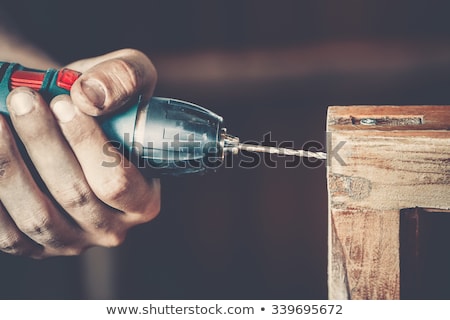 Stockfoto: Tradesman Holding Up An Electric Screwdriver