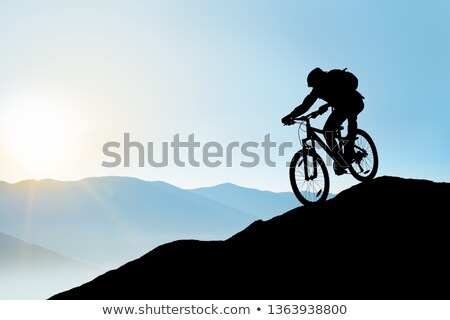 Сток-фото: Silhouette Of Downhill Mountain Bike Rider At Blue Sky