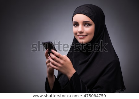 Foto d'archivio: The Muslim Woman In Black Dress Against Dark Background