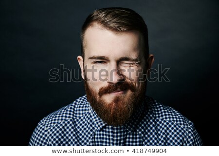 Сток-фото: Winking Red Bearded Man Studio Portrait On Dark Background