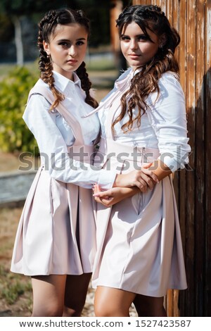 [[stock_photo]]: Two Happy Teenage Girls Showing Peace Gesture While Having Fun