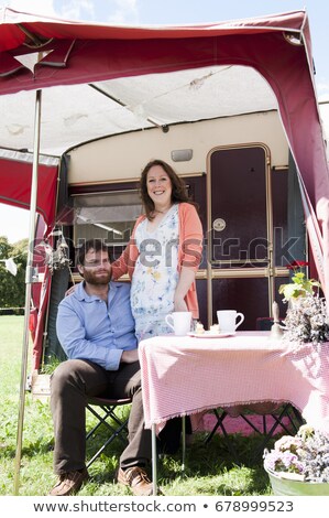 Stock photo: Couple Picnicking Outside Trailer