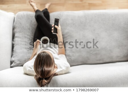 Zdjęcia stock: Young Woman With Remote Control