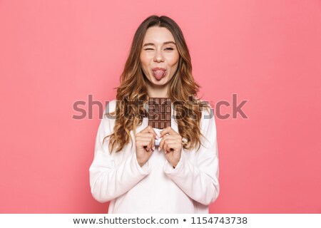 ストックフォト: Portrait Of A Funny Young Woman Holding Chocolate Bar