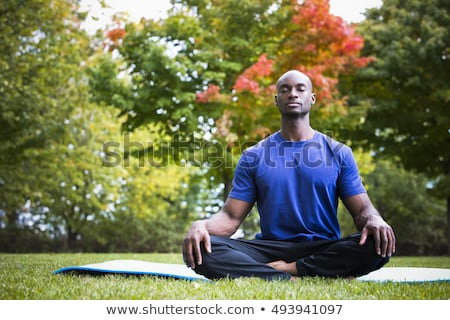 Foto stock: Man Meditating In Tree Position