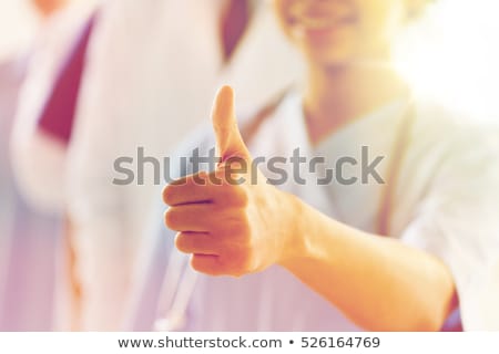 Stok fotoğraf: Smiling Female Doctor Showing Thumbs Up