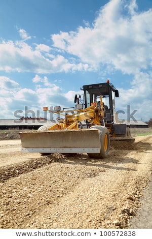Stock fotó: Grader Leveling Gravel On Road Construction Site