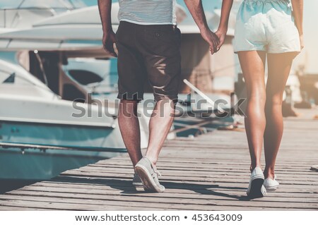 Stockfoto: Woman Walking Along The Quay With Yachts