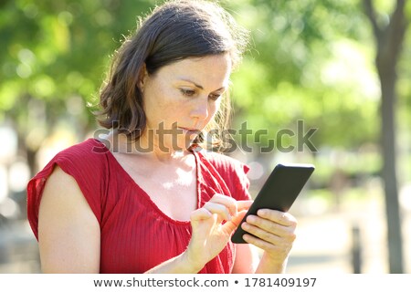 Foto stock: Serious Woman Checking Email On Phone Outdoors