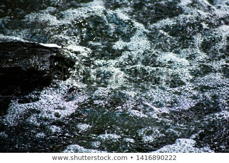 Stock photo: Raging River Flows Around Rocks