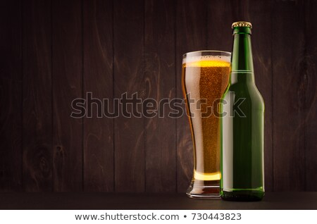 Stock foto: Green Beer Bottle And Glass Weizen With Golden Lager On Dark Brown Wood Board Vertical Mock Up