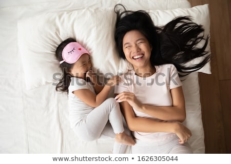 Сток-фото: Happy Family Lying On A Bed Together In The Bedroom