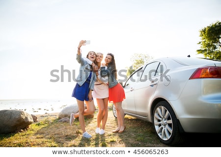 Stockfoto: Happy Teenage Girls Or Women Near Car At Seaside