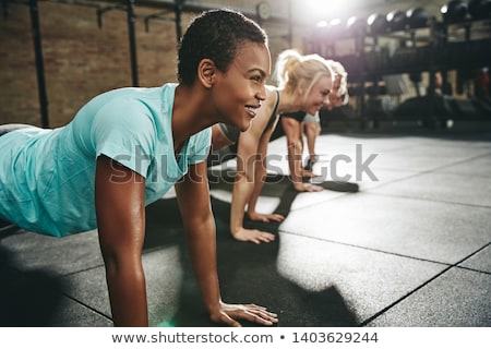 Stock photo: Group Of People Doing Pushups At Work