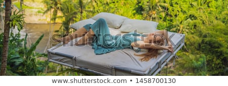 Stockfoto: Young Woman In Bed Over The Jungle Intimacy With Nature