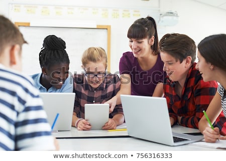 Foto stock: Group Of Students Working At Computers In Classroom