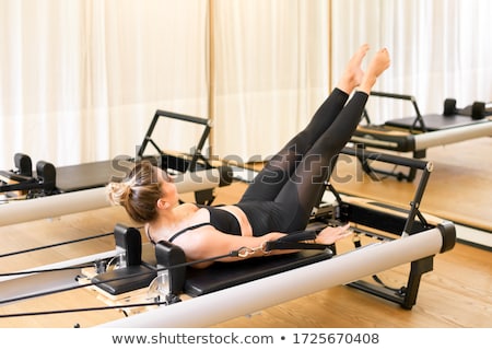 Imagine de stoc: Pilates Reformer Woman Hundred Exercise