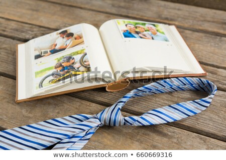 Сток-фото: High Angle View Of Photo Album By Necktie On Table