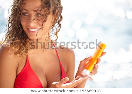 Foto stock: Blond Woman Bathing And Sun Tanning On The Beach