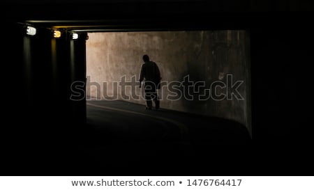 Stock foto: Man Walking With Lantern In A Dark Tunnel