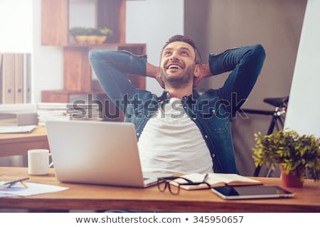 Foto stock: Smiling Creative Man With Laptop Working At Office