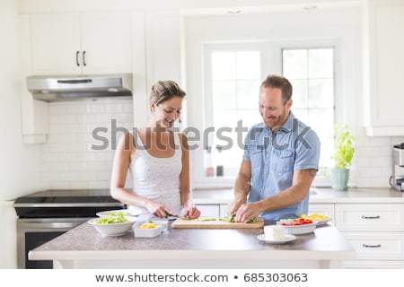 ストックフォト: Couple In The Kitchen Doing Salad Together
