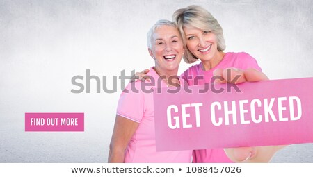 Stockfoto: Find Out More Button With Get Checked Text And Hand Holding Card With Pink Breast Cancer Awareness W