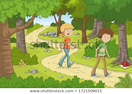 Stock fotó: A Boy Walks Through A Natural Park With Trees