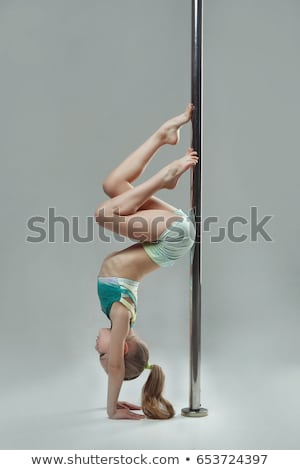 Zdjęcia stock: Woman Exercise Pole Dance On Gray Background