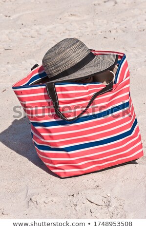 ストックフォト: Top View Of Sandy Beach With Red Striped Beach Hat Background With Copy Space And Visible Sand Textu