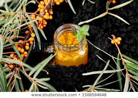 Stockfoto: Hot Sea Buckthorn Tea With Black Warm Scarf