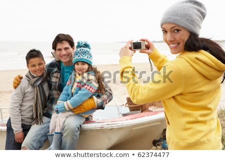 Stockfoto: Mother Taking Family Photograph On Winter Beach