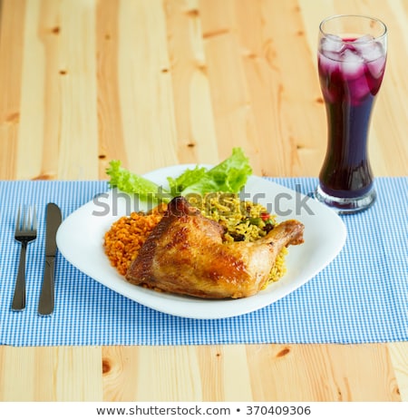 Stockfoto: Dishes From Chicken Thigh With Rice And Lettuce And A Glass Of J