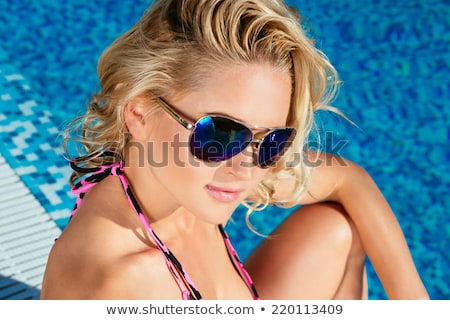 Stok fotoğraf: Close Up Of Woman Sunbathing In Lounge On Beach