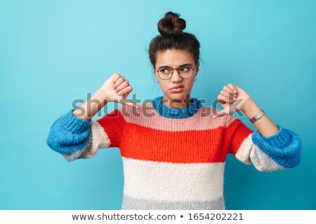 Сток-фото: Displeased Woman In Sweater And Eyeglasses With Phone