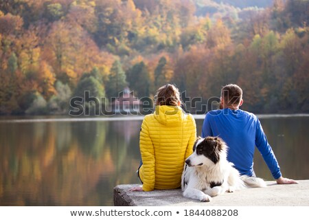 Zdjęcia stock: Couple Relaxing On Dock Of Lake