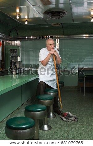 Foto d'archivio: Diner Cleaner Leaning On His Broom