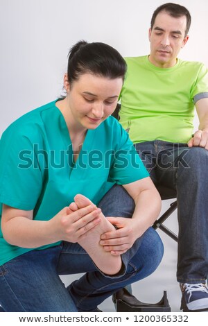 Stock foto: Physiotherapist Massaging Foot Of Young Man In Wheelchair