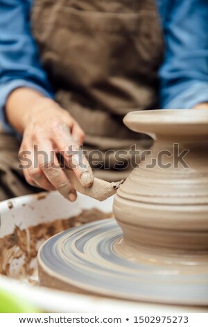 Stock foto: View At An Senior Female Artist Makes Clay Pottery On A Spin Whe