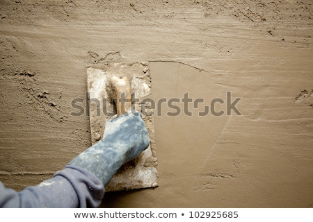 ストックフォト: Trowel With Glove Hand Plastering Cement Mortar