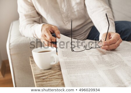 Stock photo: Man Reading The Daily Newspaper
