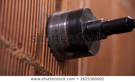 Stock photo: Craftsman Holding A Brick And An Electric Saw