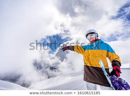 Foto stock: Young Woman Standing Balancing On A Snowboard