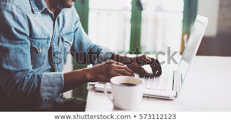 ストックフォト: Close Up Of Man Typing On Laptop Computer At Home